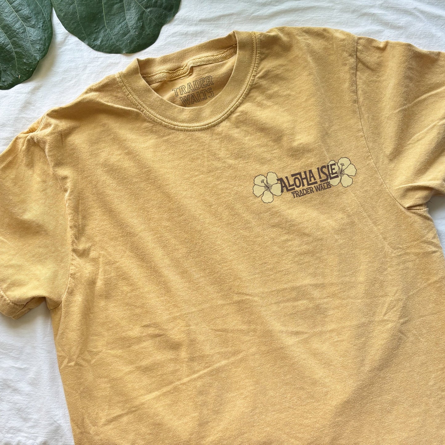 Aloha Isle front chest print with hibiscus flowers on yellow Comfort Colors tee – Disney inspired design