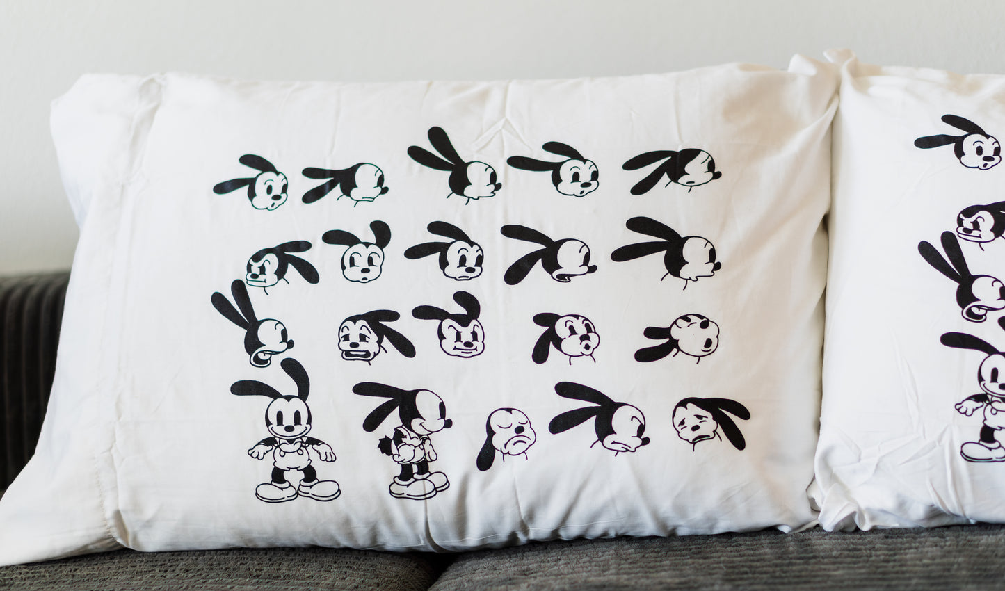 White pillowcase with vintage-style rubber-hose rabbit expressions screen-printed in black ink.
Set of pillowcases featuring classic 1920s animation-inspired rabbit character faces.
Lucky Rabbit pillowcase design showing multiple expressive cartoon poses in retro art style.