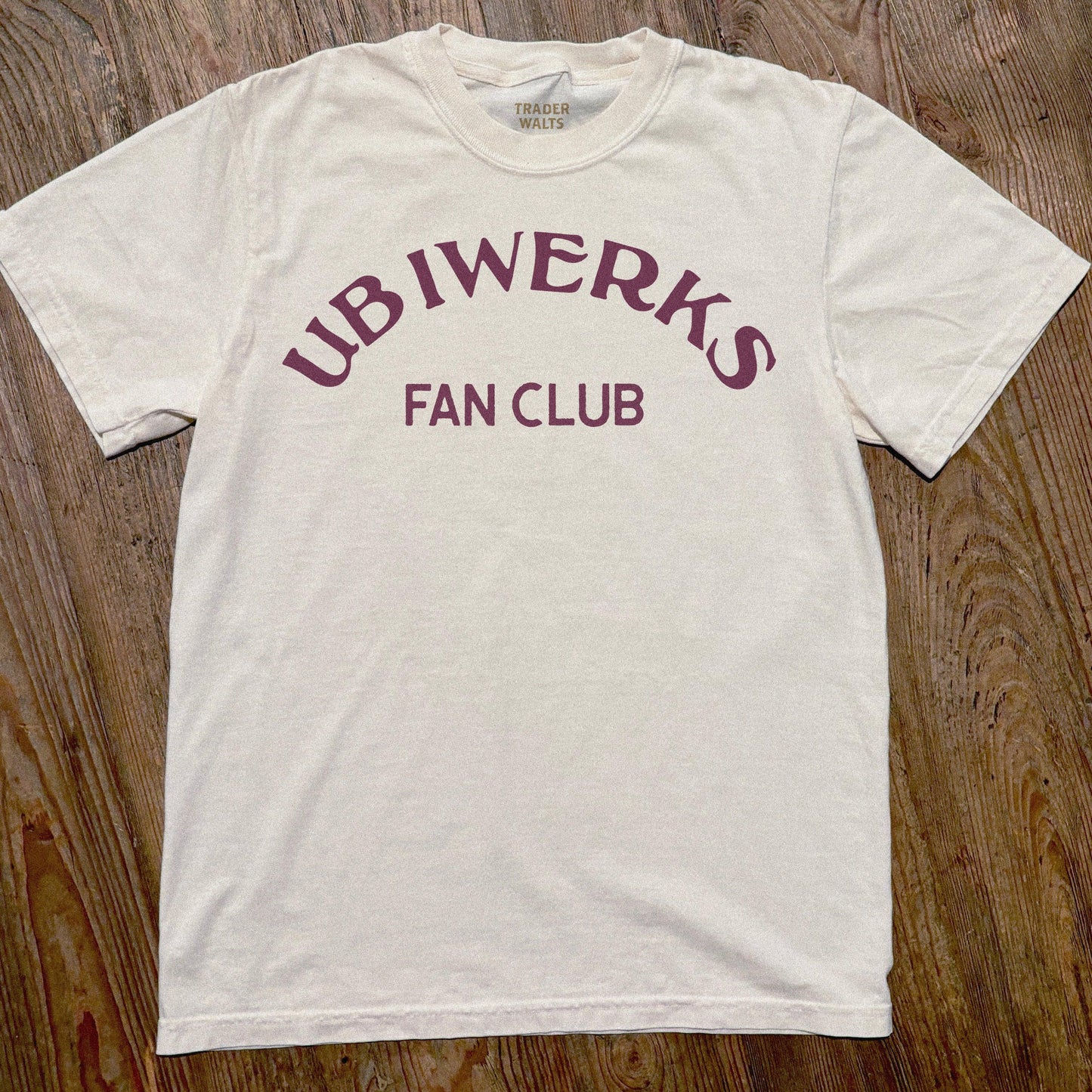 Front view of natural cotton Ub Iwerks Fan Club T-shirt with vintage lettering.
Close-up of maroon Ub Iwerks Fan Club print on natural garment-dyed cotton tee.
Flat lay of Ub Iwerks Fan Club subtle Disney-inspired shirt.