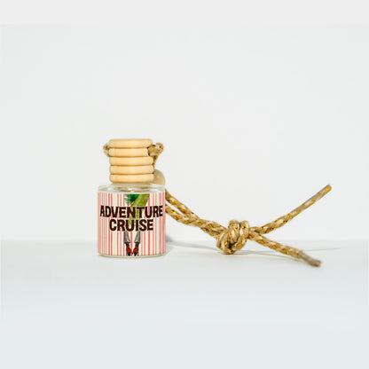 Adventure Cruise car freshener by Trader Walt’s with tropical orchid, palm, and fern scent.

Botanical-themed candle tin labeled Adventure Cruise, inspired by lush jungle fragrance.

Adventure Cruise candle tin featuring Trader Walt’s Parkes Collection design.