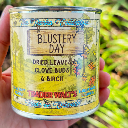 Trader Walt’s ‘Blustery Day’ candle inspired by the Winnie the Pooh storybook world, with autumn scents of dried leaves, clove buds, and birch. The Parks Collection label features a cozy, storybook-style forest design.