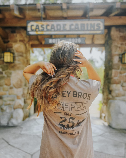 Woman wearing Disney Bros. Coffee back-print tee at Disney’s Wilderness Lodge Cascade Cabins – Trader Walt’s park-inspired coffee shirt