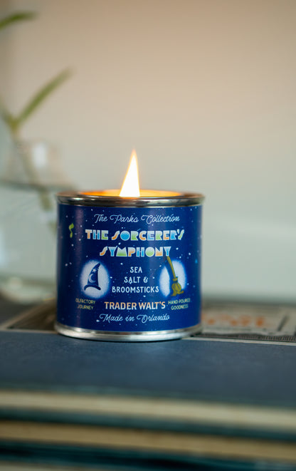 Blue Sorcerer’s Symphony candle by Trader Walt’s with flame lit, inspired by magical symphonies and ocean-amber-oakwood scents.