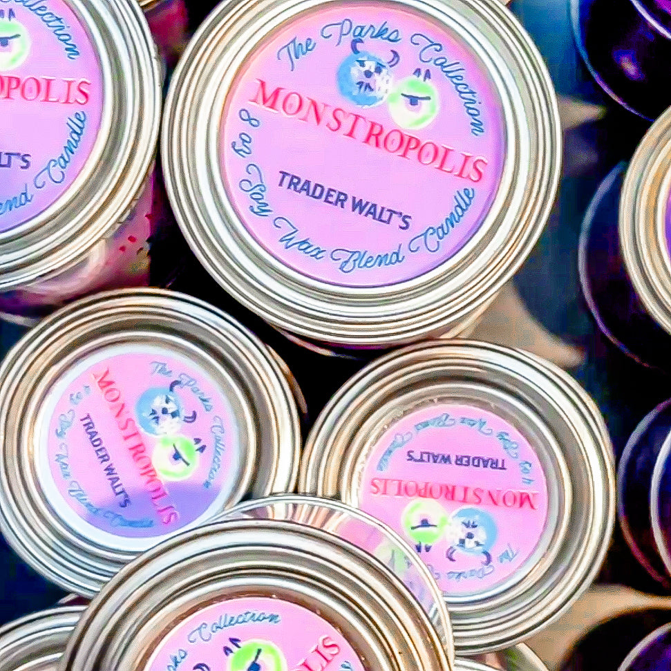 Trader Walt’s candle lineup featuring the Monstropolis citrus cereal tin candle alongside other nostalgic, hand-poured fragrance tins.