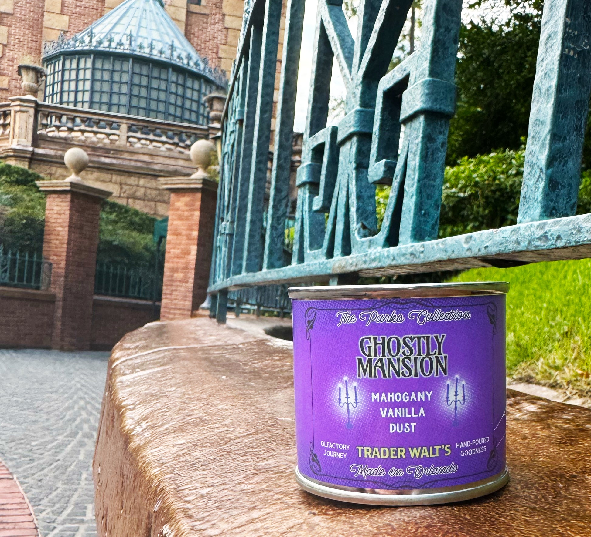 Ghostly Mansion purple tin candle by Trader Walt’s with Haunted Mansion–inspired design and mahogany, vanilla, and dust fragrance notes.