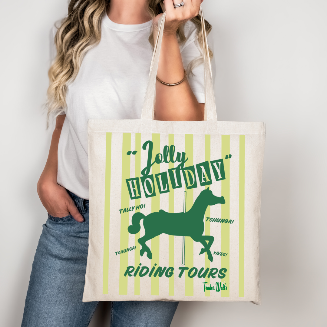 Person holding a tote bag with 'Jolly Holiday Riding Tours' design on a plain background