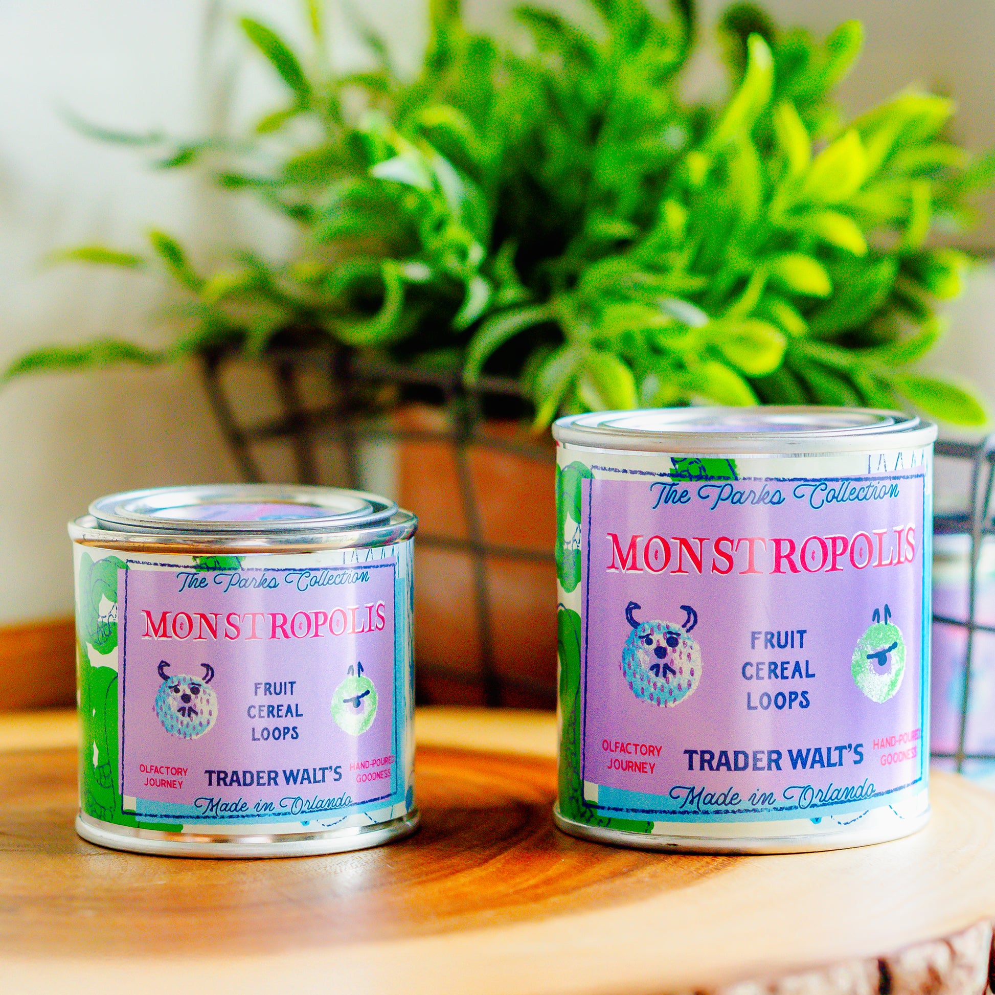 Monstropolis citrus and fruity cereal scented tin candle by Trader Walt’s, featuring playful monster-inspired pastel artwork and a hand-poured metal tin design.