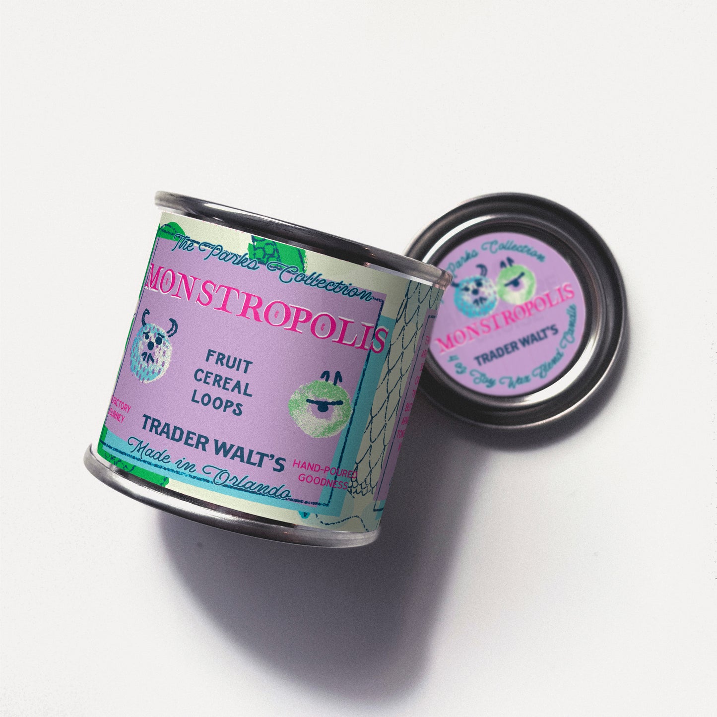 Monstropolis citrus and fruity cereal scented tin candle by Trader Walt’s, featuring playful monster-inspired pastel artwork and a hand-poured metal tin design.