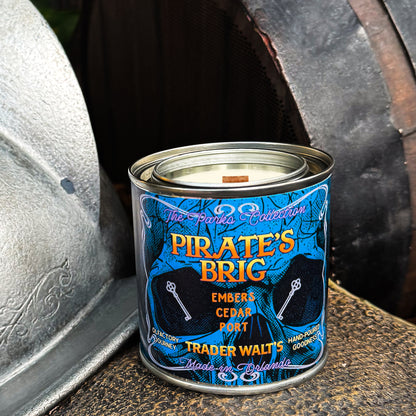 Pirate’s Brig 8 oz candle tin styled with smoky port and cedar fragrance by Trader Walt’s.

Blue Pirate’s Brig candle tin inspired by pirate-era ambiance with smoke and cedar notes.