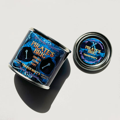 Pirate’s Brig 8 oz candle tin styled with smoky port and cedar fragrance by Trader Walt’s.

Blue Pirate’s Brig candle tin inspired by pirate-era ambiance with smoke and cedar notes.